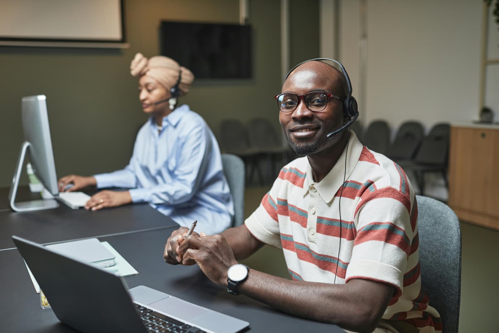 Smiling call center agent wearing a headset